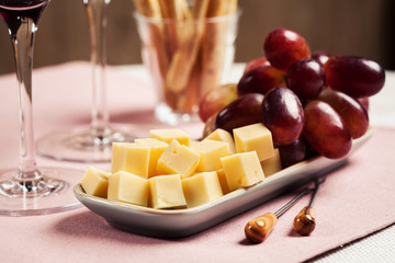 Two glasses of red wine with snacks