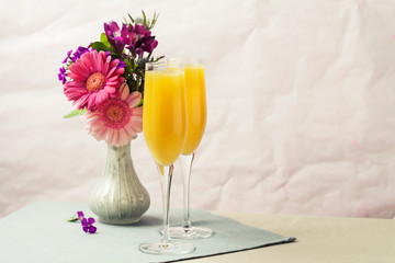 Mimosa cocktail and flowers