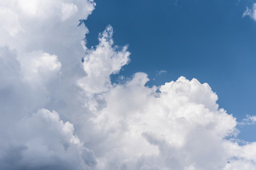 Blue sky background with a fluffy clouds
