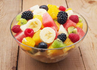fresh healthy fruit salad on wooden background