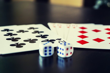 dice with cards on the table
