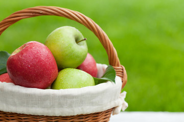 Fresh garden green and red apples in basket