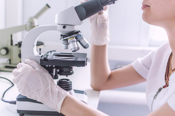 Hands with microscope in the laboratory