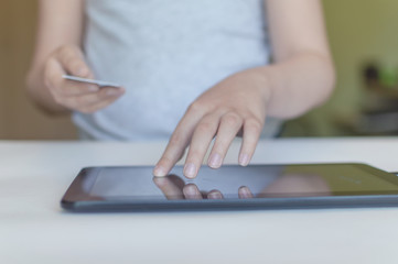 girl child uses a bank card to purchase in secret from parents