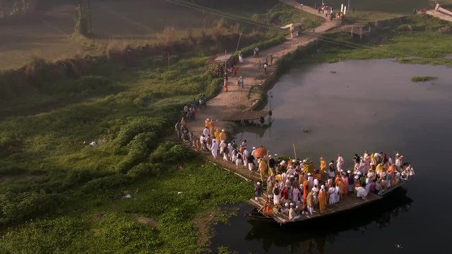 Hare Krishna pilgrims procession in a boat, Mayapur, India, 4k aerial 