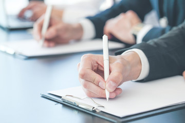 Business people writing notes