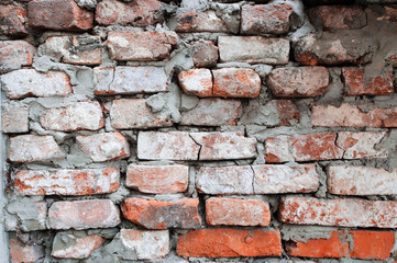 Old brick wall, old texture of red stone blocks closeup.