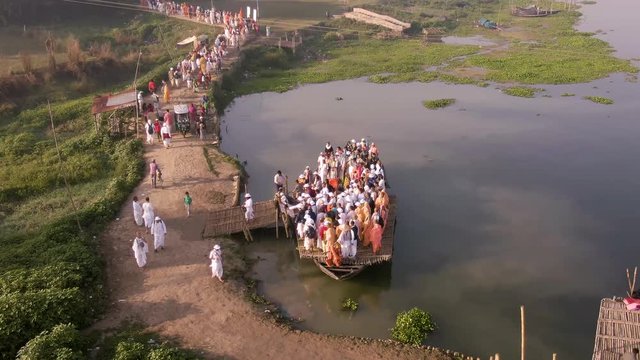 Hare Krishna pilgrims procession in a boat, Mayapur, India, 4k aerial 