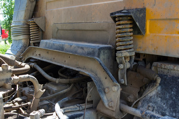 yellow dump truck cab rear shock absorbers