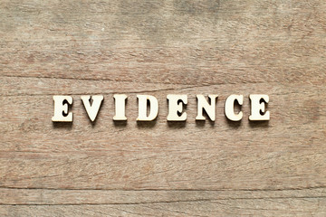 Letter block in word evidence on wood background