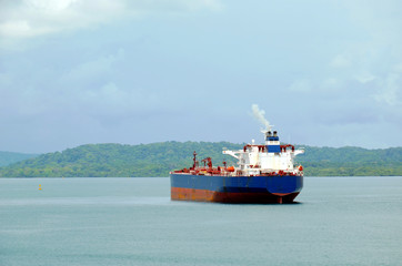 Obraz premium Cargo ship entering Panama Canal in the Cristobal, Panama. 