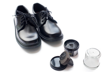 Black leather shoes shoe polish white background