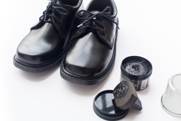 Black leather shoes shoe polish white background