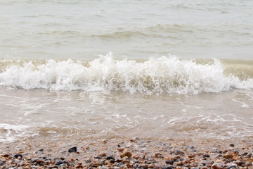 sea waves crashing at sunny beach