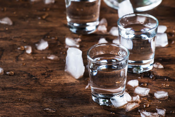 Aguardiente - traditional Spanish strong alcoholic drink, grape moonshine or vodka, in glasses on...