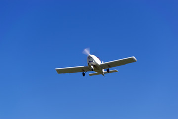 Fototapeta na wymiar A light motor plane on a blue sky