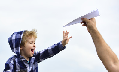 Childhood. Child son playing with paper airplane. Carefree. Freedom to Dream - Joyful Boy Playing With Paper Airplane. Dream of flying. Enjoy.