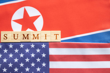 Concept of bilateral relations of USA and North Korea showing with flag and summit in wooden block...