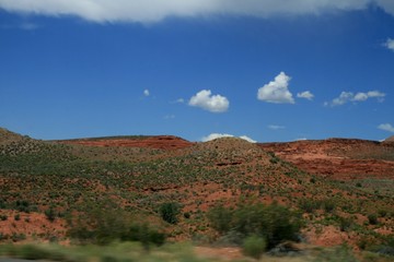 USA.  Red mountains Utah. Gray Mountains in Utah. View from the highway from car. Spring, fine weather. Grass on the rocks