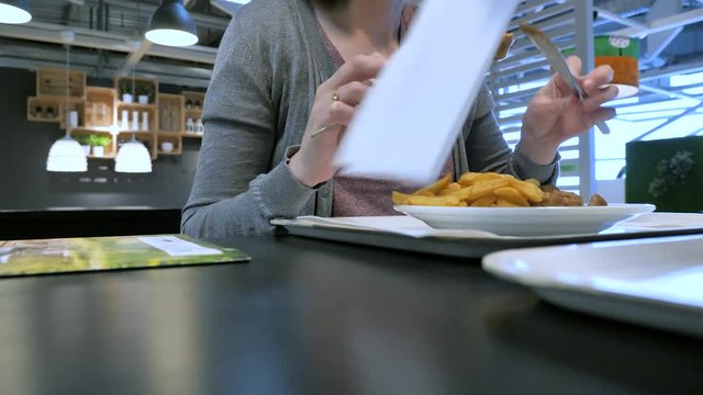 Woman man inside food restaurant eating French fries and traditional Swedish meatballs