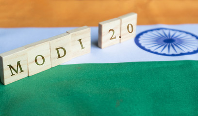 MAski, India - June, 09 2019 : Modi 2.0 wooden block letters on Indian Flag