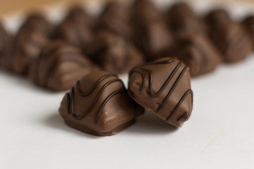 Chocolate candy on white background. Chocolate truffle sweets closeup.