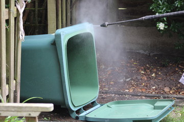 washing out the wheelie bin