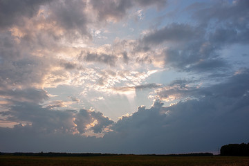 The sky before the storm. Dark clouds and rays of the sun through the clouds. Can be the background.