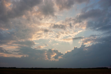 The sky before the storm. Dark clouds and rays of the sun through the clouds. Can be the background.