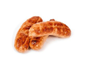 Meat sausages with glitter on a light background. Fried sausage. The concept of traditional cuisine.