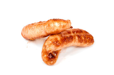 Meat sausages with glitter on a light background. Fried sausage. The concept of traditional cuisine.