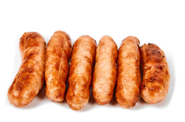 Meat sausages with glitter on a light background. Fried sausage. The concept of traditional cuisine.