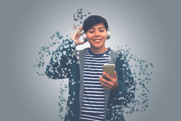  Asian young man is happy and smile listening music on mobile phone dissolving into pixels on gray...