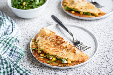 Potato rosti with corn and rocket salad served on a gray background. Traditional swiss dish