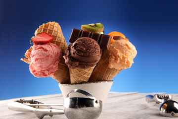 ice cream scoops of different colors and flavours with berries, nuts and fruits decoration on white...