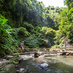 Woman near Nung Nung waterfal on Bali, Indonesia