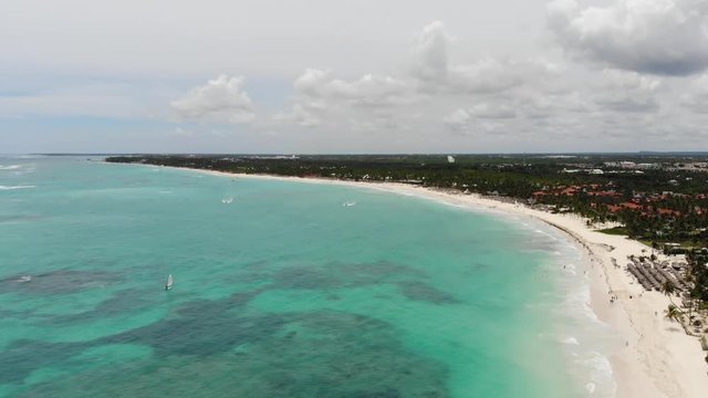 Aerial wide angle panning shot of small fishing and motor boats anchored at Dominicana, an island in the Caribbean
