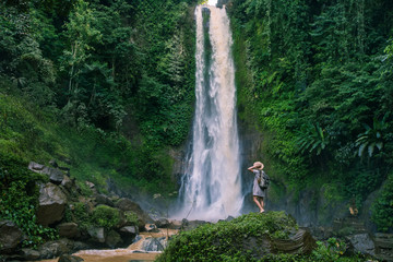  Woman near waterfal Git Git on Bali, Indonesia 