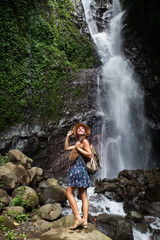 Naklejka na ściany i meble Woman near waterfal on Bali, Indonesia 