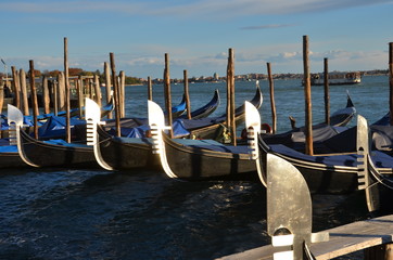group of famous Venetian gondolas on a sunny day, Venice, Italy, Europe 