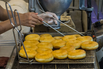 Female Chef Fried doughnut in Berkeley shop Food Dessert Concept