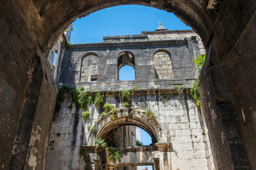 Stone houses with windows and balconies in narrow street of old town of Split, Croatia, inside the palace of Roman emperor Diocletian