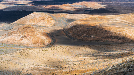 Mars like landscape on the spectacular volcanic island of Lanzarote, Canary Spain. View from the Caldera Blanca volcano over solidified black lava streams and rock formations.