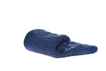 Dark blue terry towel isolated on white background.