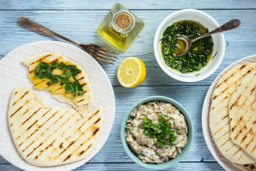 Pita bread with eggplant dip, olive oil and herbs, mediterranean cuisine.