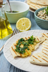 Pita bread with eggplant dip, olive oil and herbs, mediterranean cuisine.