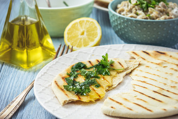 Pita bread with eggplant dip, olive oil and herbs, mediterranean cuisine.