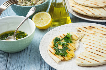Pita bread with eggplant dip, olive oil and herbs, mediterranean cuisine.
