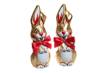 A chocolate figures of two rabbits with golden foil and red ribbon, on white background