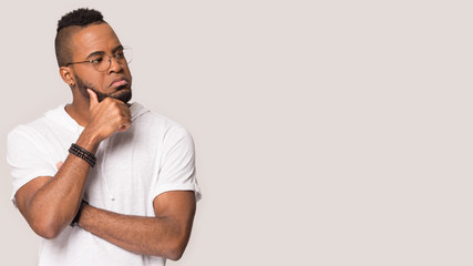 Pensive focused african guy look aside at copyspace studio shot